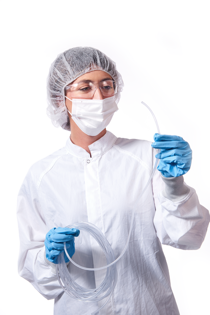 medical professional standing holding tygon medical tubing