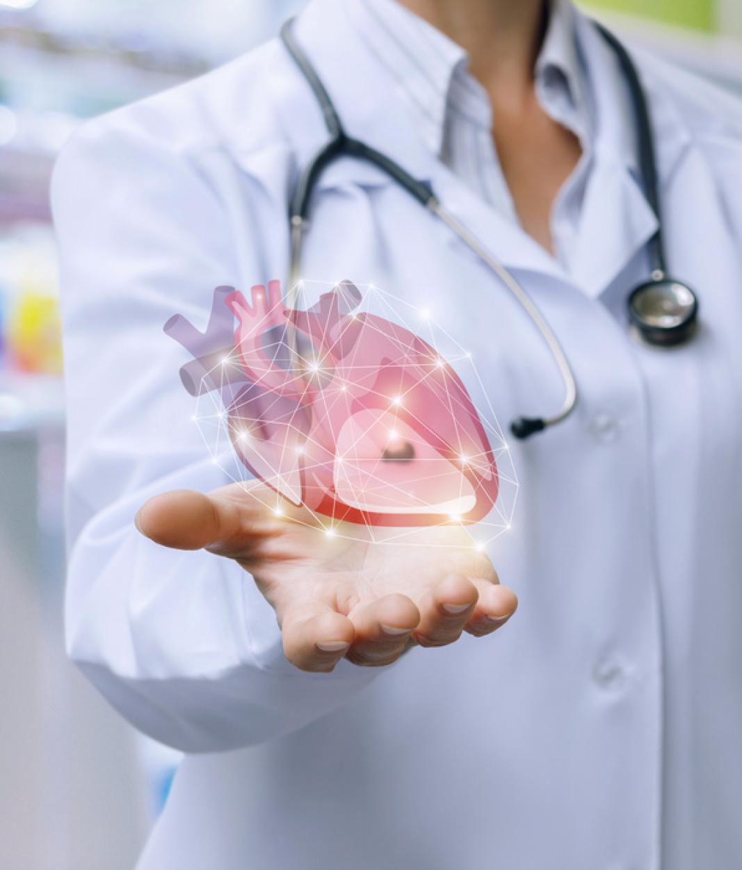 doctor in lab coat holding illustrated heart in hand