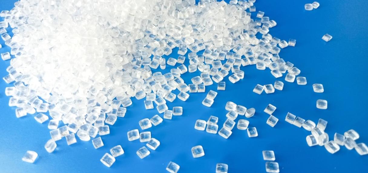 raw material, plastic polymer granules on blue background