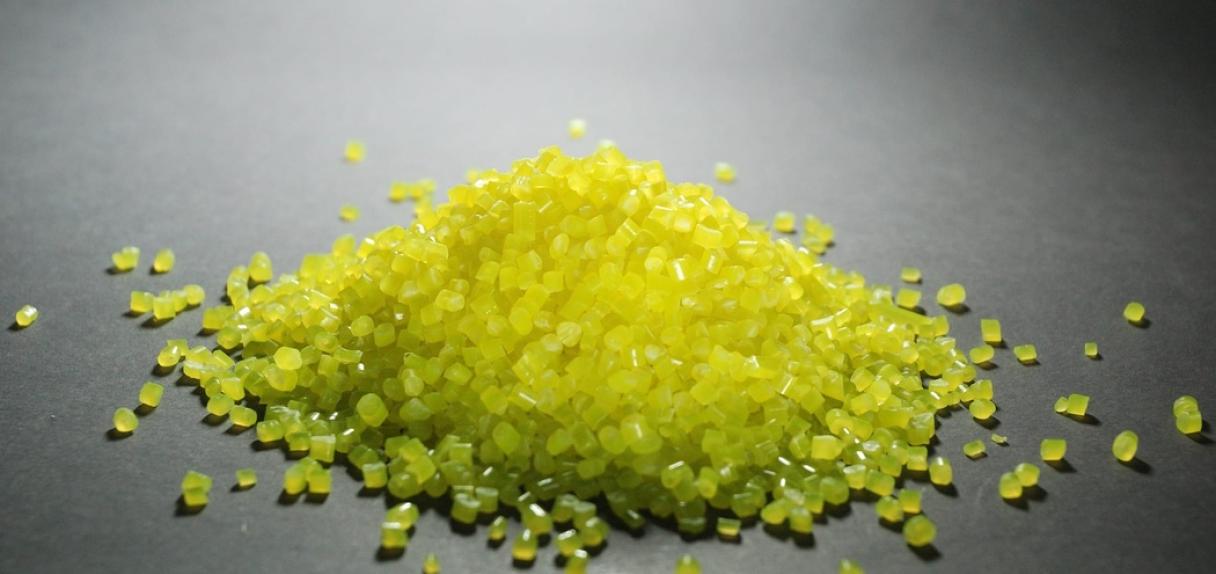 A polymer material in yellow on grey background