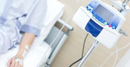 patient in hospital bed with IV