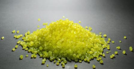 A polymer material in yellow on grey background