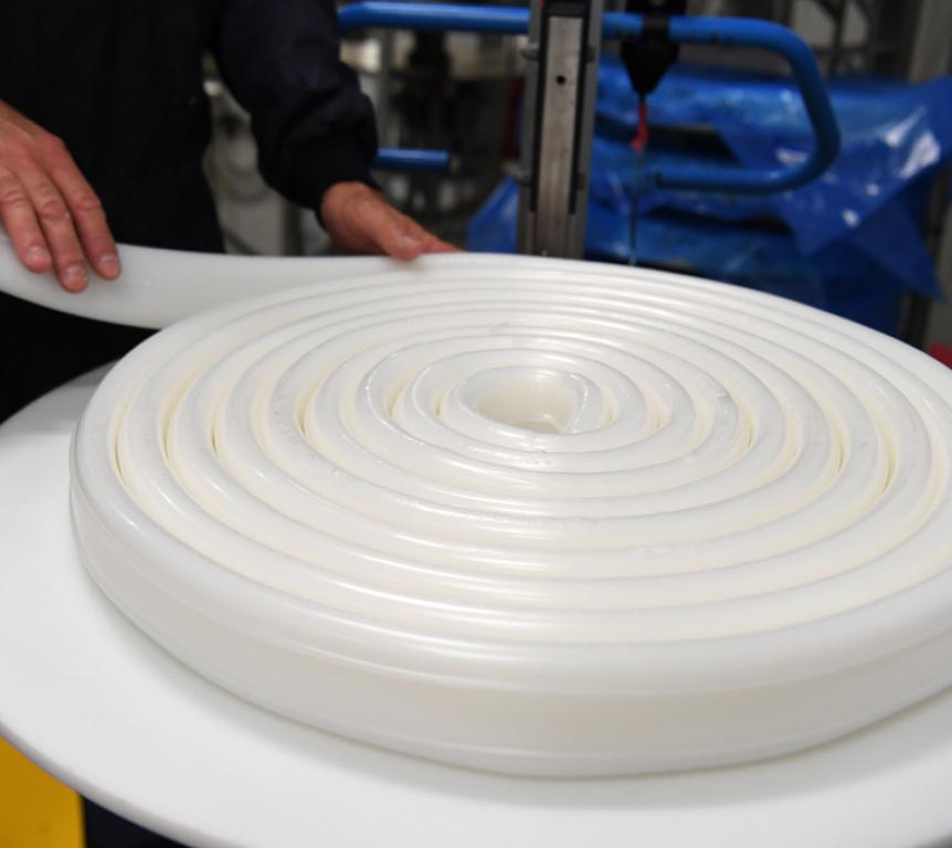 Silicone material being rolled by employee